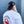 Man wearing black crabcakes and cannabis snapback and white crab emblem tee shirt, standing on a grey wall. 